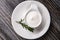 White plate full of sour cream on wooden table