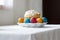 White plate with a glazed easter cake and painted eggs standing on a table covered with a white cloth