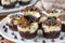 A white plate holds decadent chocolate cupcakes with luscious white frosting, creating a heavenly dessert spread for any