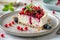 A white plate holds a delectable slice of cheesecake topped with a generous portion of assorted fresh berries, creating