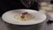 White plate with pasta standing on table in kitchen of house.