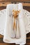 White plate serviette fork knife dried flowers