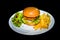 A white plate setup showing a delicious ready to eat juicy burger with a patty, lettuce & mayonnaise