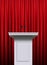 White podium over red curtain background