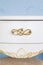 White polished chest of drawers with golden handles. Luxurious chest of drawers in a classic style. Vertical photography