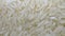 White polished long rice close-up in macro mode rotates in a circle. grocery background high dynamic range