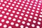 White polka dots on red background