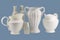 White porcelain jugs and bottles on a blue background