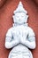 White, porcelain statuette of sitting meditating Buddha