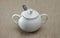 White porcelain sugar bowl with lid and spoon.