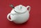 White porcelain sugar bowl with lid and spoon.