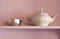 White porcelain teapot and metal sugar bowl on a p