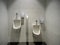 White porcelain urinals in a clean male public toilet