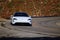 White Porsche Taycan driving at the Angeles Crest Highway, California