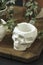 White pots for plants with succulents in the shape of a skull made of plaster, concrete. Creative Halloween floral