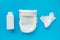 White powder, diaper, cream, napkin on a blue background, flatley, top view, copy space, mock up. Baby hygiene, background for