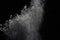 White powder explosion on black background.White dust explosive