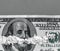 White powder in the form drugs on the Ben Franklin`s mouth under the nose of hundred-dollar bill. Concept