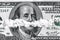 White powder in the form drugs on the Ben Franklin`s mouth under the nose of hundred-dollar bill. Concept