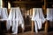 white prayer shawls draped over wooden chairs