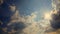 White puffy clouds move across a brilliant blue sky