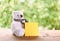 White puffy teddy bear toy sit alone on wood table with green bl