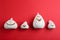White pumpkin shaped candle holders on red background. Halloween decoration