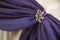 White and purple drapes with brooches