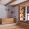 White and purple farmhouse bathroom with wooden bathtub. Window with bench and pillows, plaster concrete walls. Japandi interior