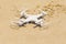 White quadrocopter on sand, close-up
