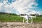 White quadrocopter standing on the ground