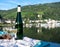 White quality riesling wine served on old bridge across Mosel river with view on old German town in sunny day