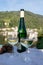 White quality riesling wine served on old bridge across Mosel river with view on old German town in sunny day