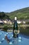 White quality riesling wine served on old bridge across Mosel river with view on old German town in sunny day