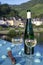 White quality riesling wine served on old bridge across Mosel river with view on old German town in sunny day