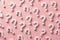 white question marks on pink backdrop, illustrating questioning, seeking answers, and the unknown