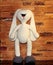 White rabbit. White stuffed toy. Knitted toy with your own hands. Rabbit without clothes