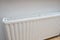 White radiator of a central heating system, warm and cozy home concept