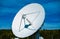 White radio antenna dish with blue skies background