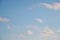 White ragged clouds on a light blue sky.