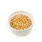 White ramekin filled with corn kernels