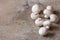 White raw champignons closeup on a wooden background. Group of fresh mushrooms on a wooden table.