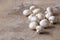 White raw champignons closeup on a wooden background. Group of fresh mushrooms on a wooden table