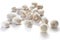 White raw whole champignons. Cultivated edible mushrooms. Objects on a white background