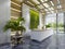 White reception desk in an office building with a green wall and illuminated wood paneling and flowerpots