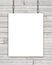White rectangular poster hanging on chain over wooden background