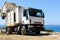 White recycling truck stays near Paleochora town on Crete island, Greece