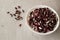 White and red beans in a white bowl on a gray background. Beans are a healthy, tasty and satisfying product