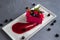White, Red bright ice cream with blueberry, blackberry and caramel in a white plate. Creative serving dishes. Top view, grey