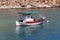 White and red docked vintage wooden motor boat at sea